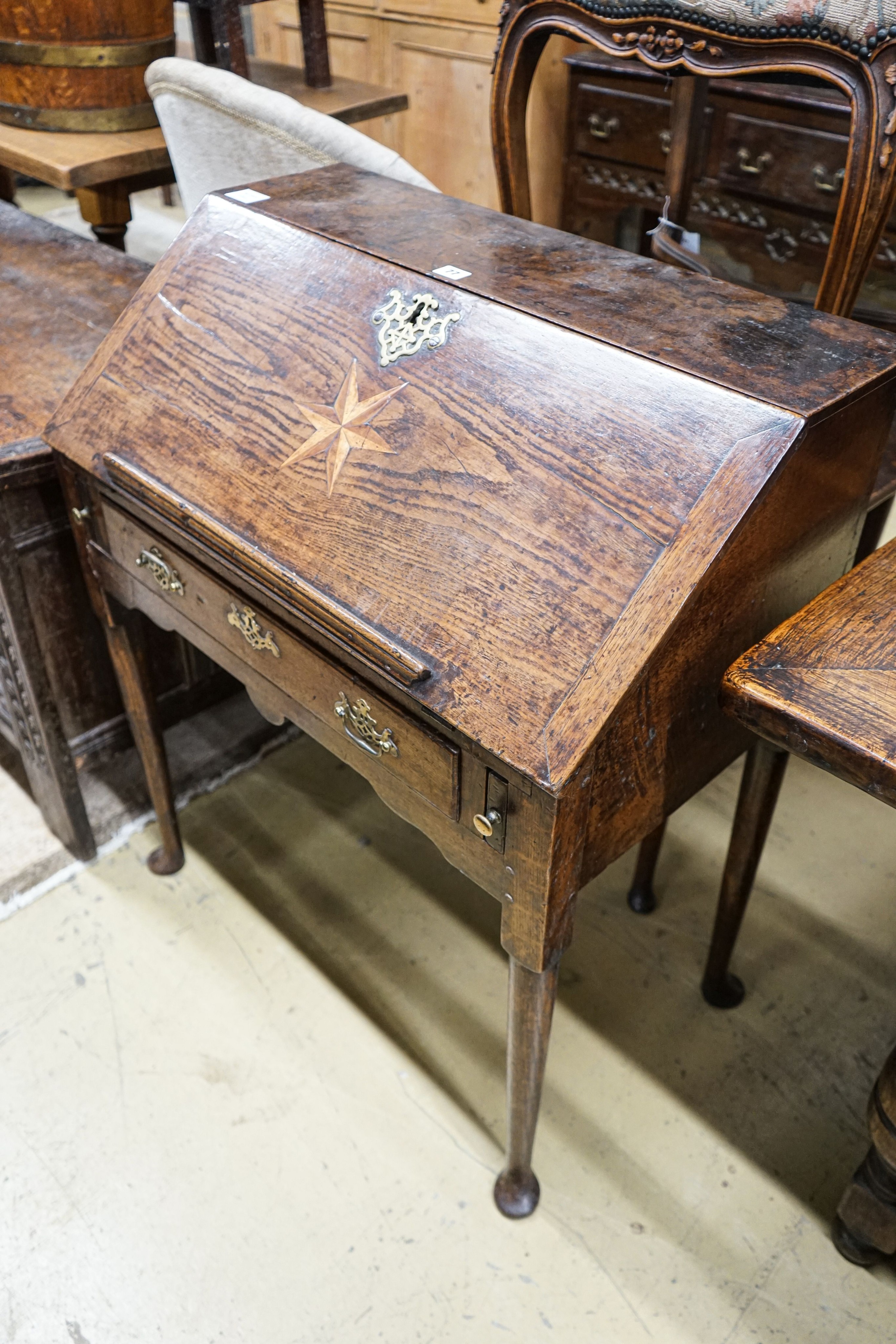 A mid 18th century inlaid oak and elm bureau, with fitted interior and single drawer, width 77cm, depth 45cm, height 94cm